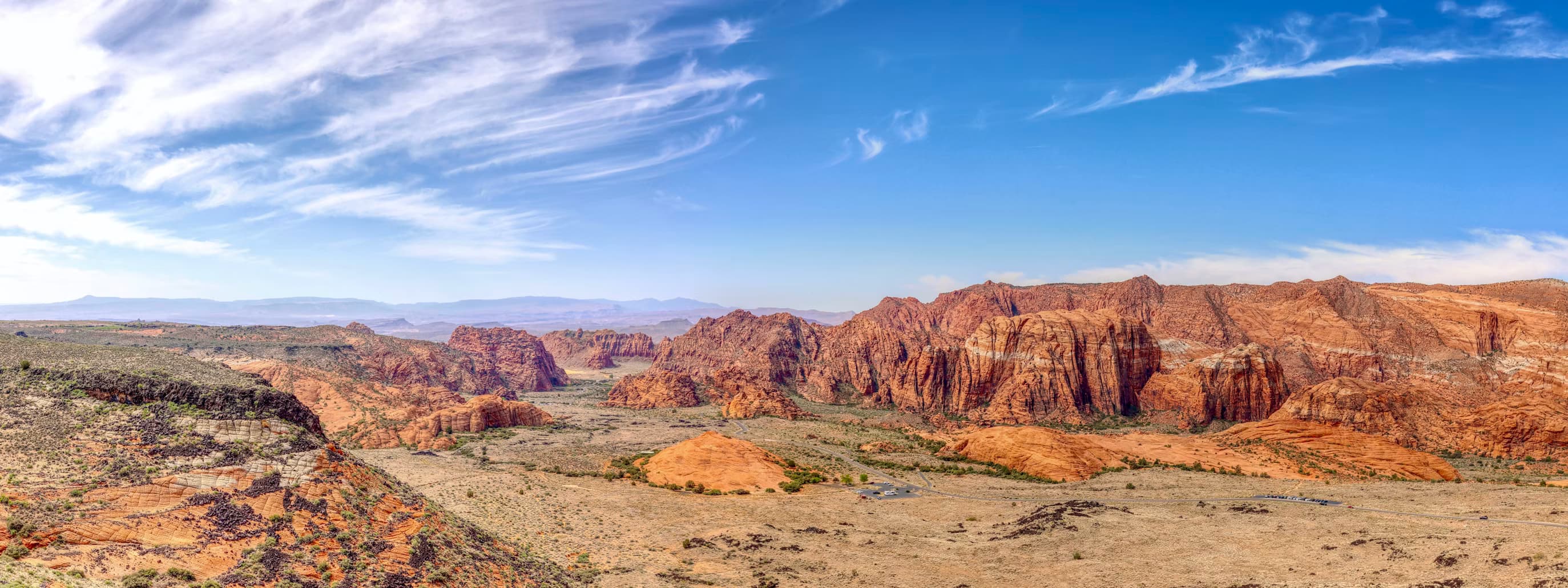 Panoramic view of the red rock cliffs and desert floor of Snow Canyon State Park near St. George, Utah